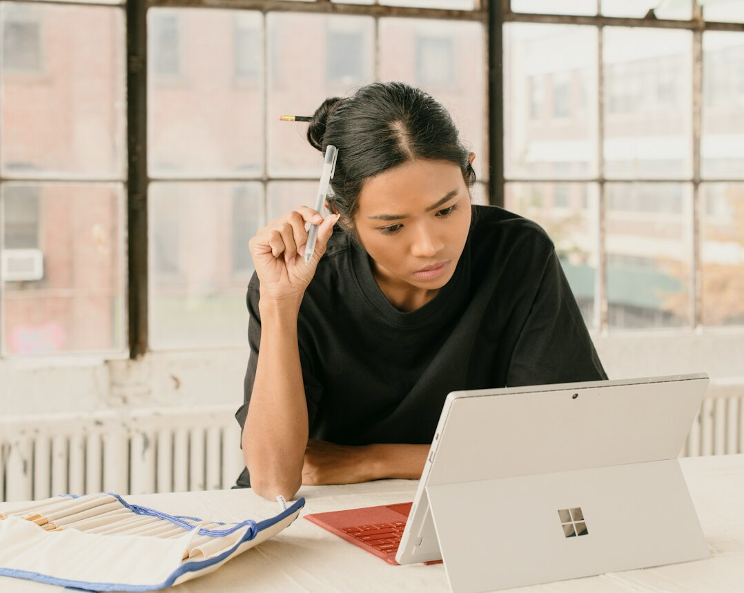 woman focused on laptop screen